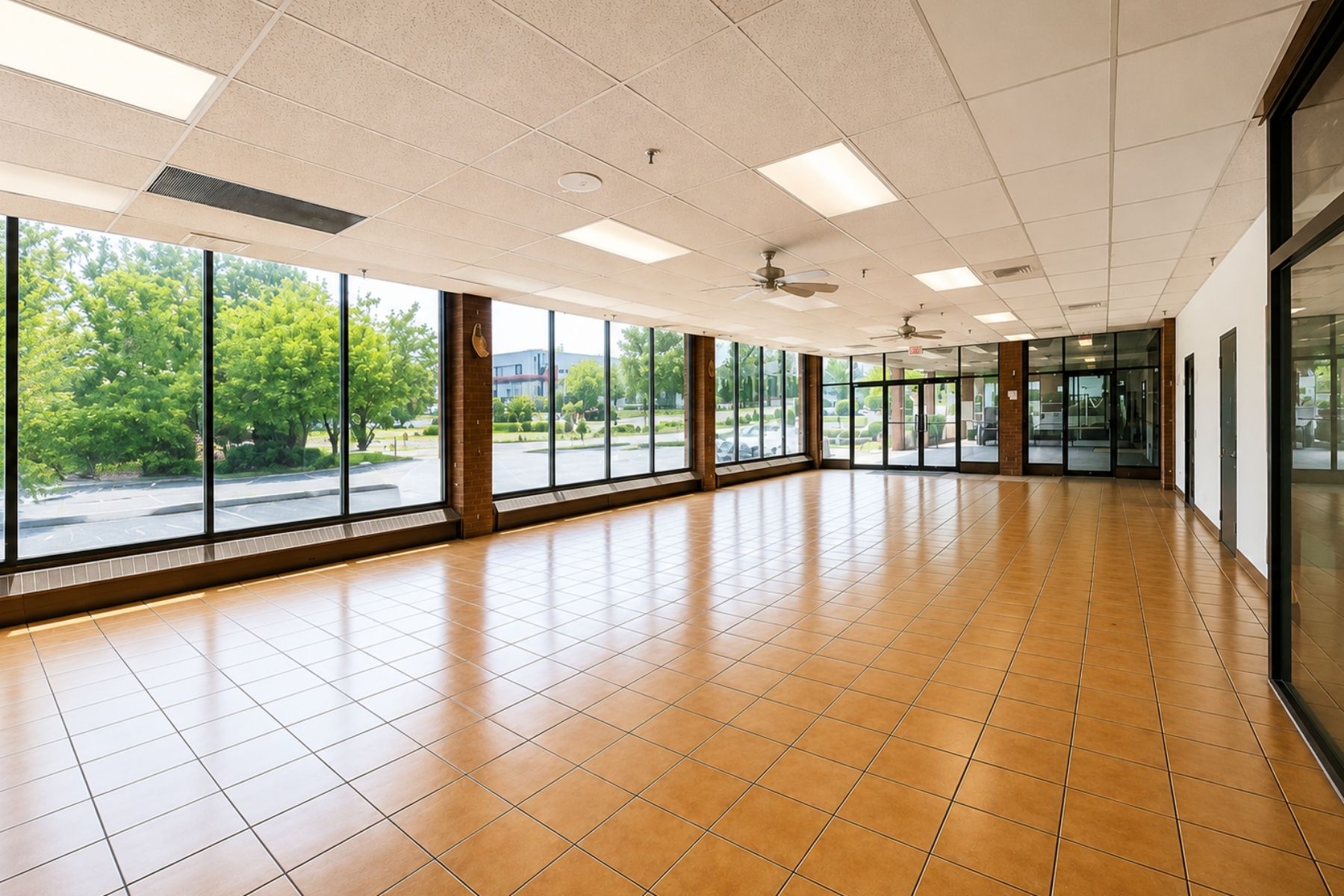 Bright, First-Floor Retail Showroom With Soaring Ceilings and Expansive Window Walls Bright interior retail showroom space with high ceilings and large window walls.