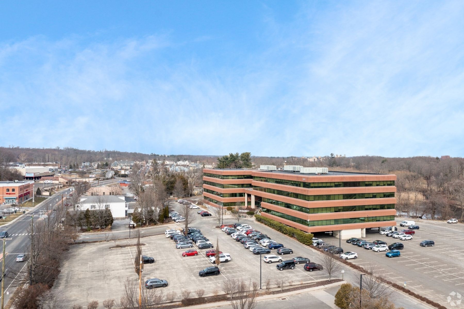 Ample Parking - 501 Kings Highway East Fairfield CT View of the large parking lot at 501 Kings Highway East with 530 shared spaces and designated covered parking areas.