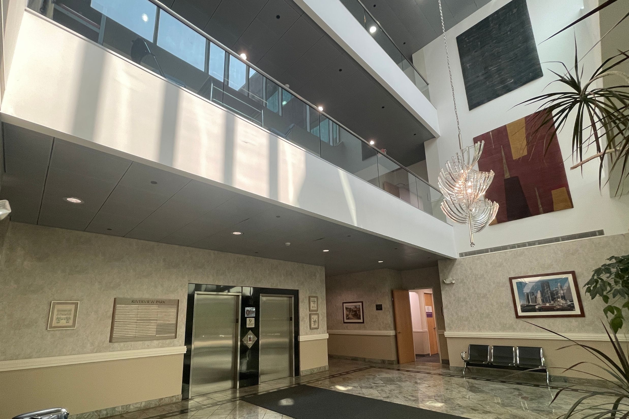 Professional Lobby Atrium - 501 Kings Highway East Dramatic four-story building lobby at 501 Kings Highway East featuring a large atrium, marble flooring, and high-end finishes