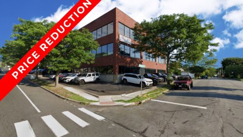 Commercial building at 430 Tunxis Hill Road in Fairfield, CT, featuring a "Price Reduction" banner and a large parking lot.