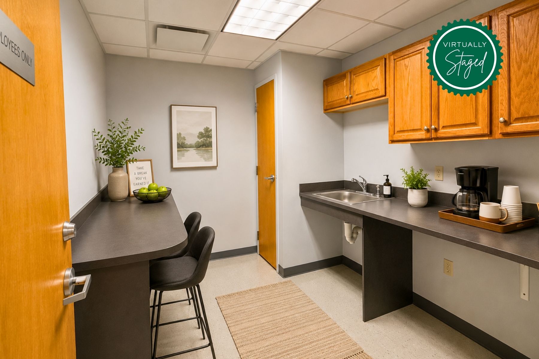 Second Floor Suite - Virtually Staged Kitchenette Virtually staged second-floor commercial office kitchenette at One Post Road in Fairfield, CT, featuring wooden cabinetry, dark countertops, and a casual seating area.