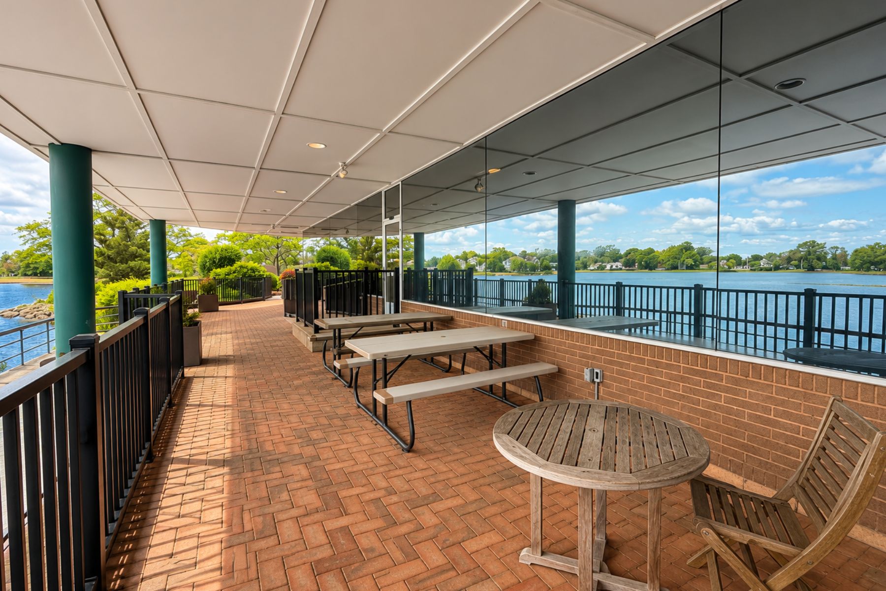 First Floor Suite has Exclusive Use of Outdoor Brick Patio With Seating and Direct Access to Water Views Covered outdoor brick patio featuring picnic tables and direct waterfront views of Ash Creek at the One Post Road commercial office building in Fairfield, CT.
