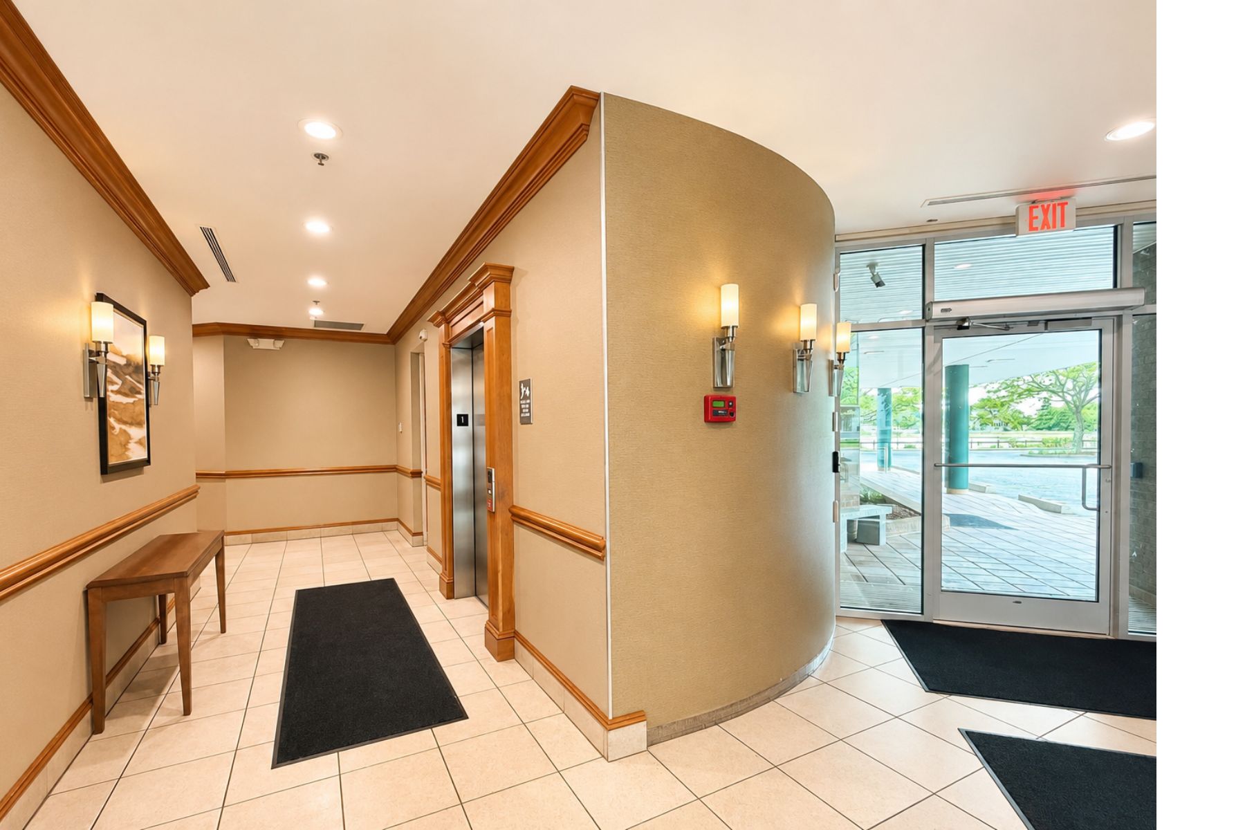 Elegant Common Area With Marble Floors and Automatic ADA-Compliant Entrance Door Elegant common area and lobby at the One Post Road commercial office building in Fairfield, CT, featuring marble floors, rich wood trim, and an ADA-compliant automatic entrance door.