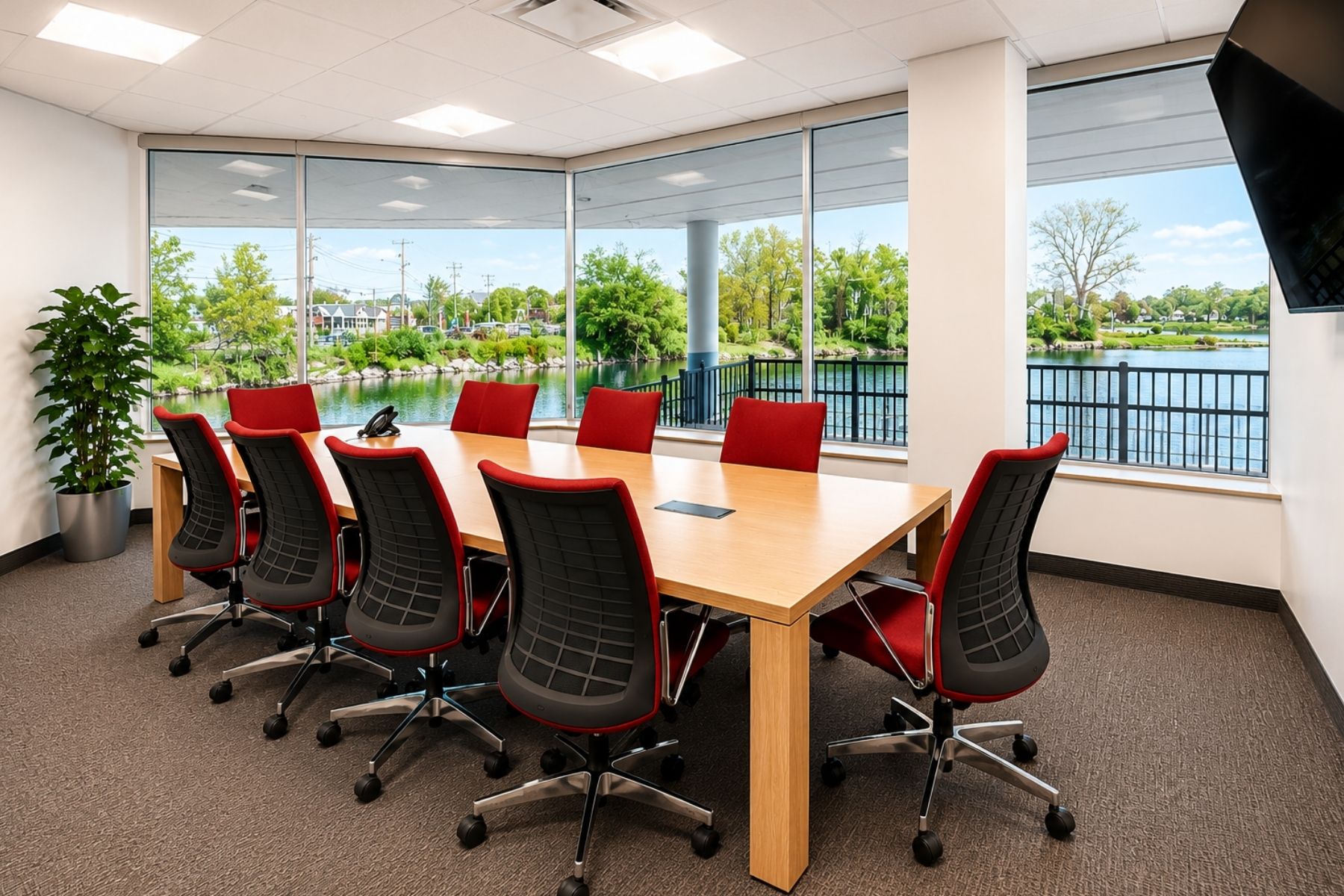 First Floor Suite -Bright Glass-Walled Conference Room Overlooking Ash Creek Bright, glass-walled conference room featuring waterfront views of Ash Creek at the One Post Road commercial office building in Fairfield, CT.