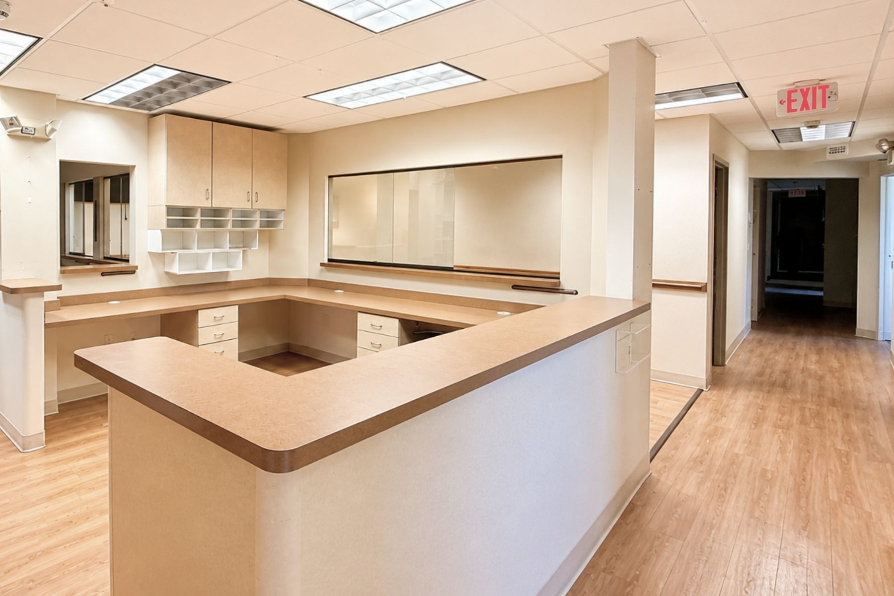 Reception Desk Interior view of a modern wrap-around wooden reception desk and counter in a medical office suite at Hawley Lane Professional Center in Trumbull, CT.