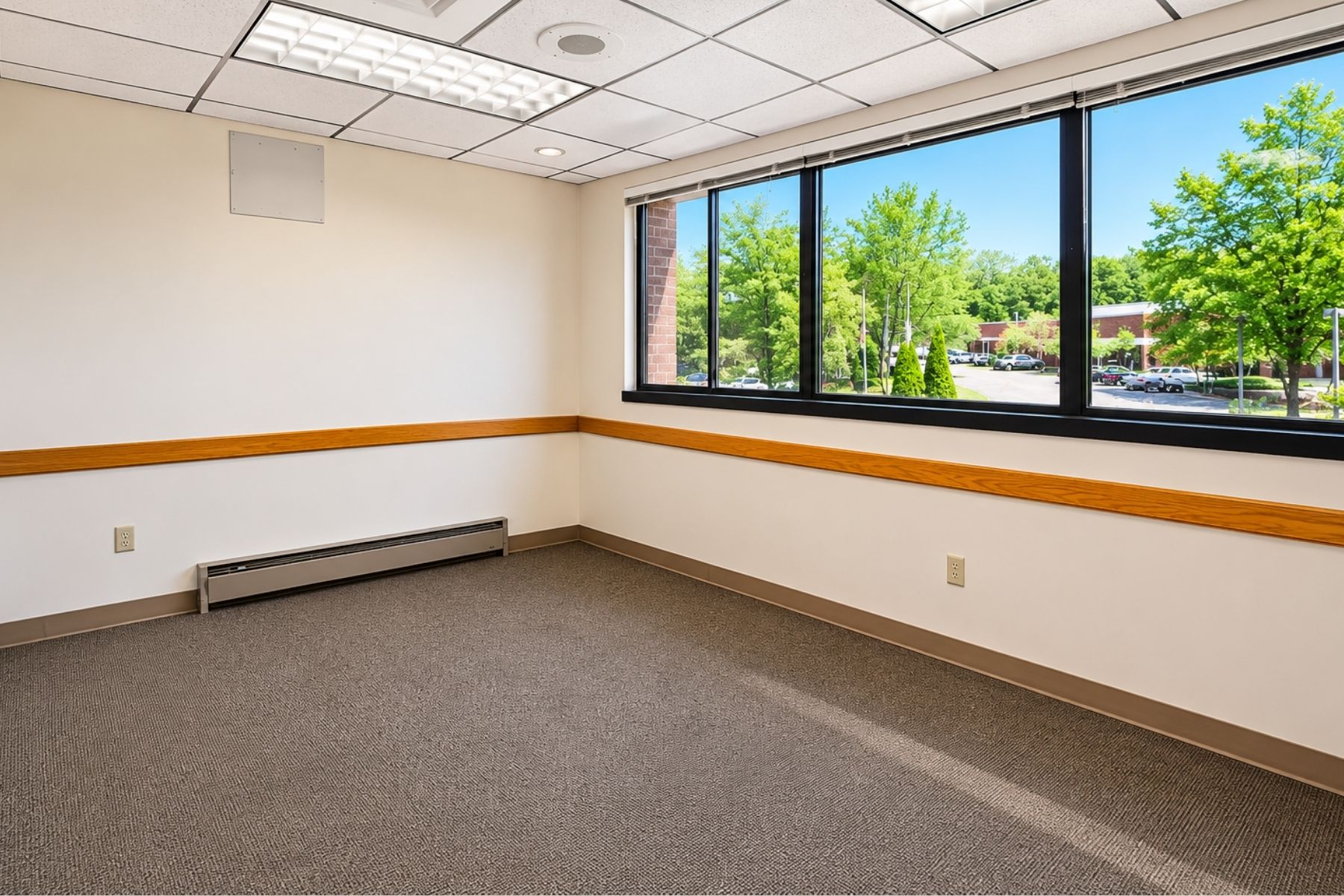 Bright Corner Suite with Offices Along Perimiter Interior view of a bright, window-lined corner office suite with views of surrounding trees at Hawley Lane Professional Center in Trumbull, CT.