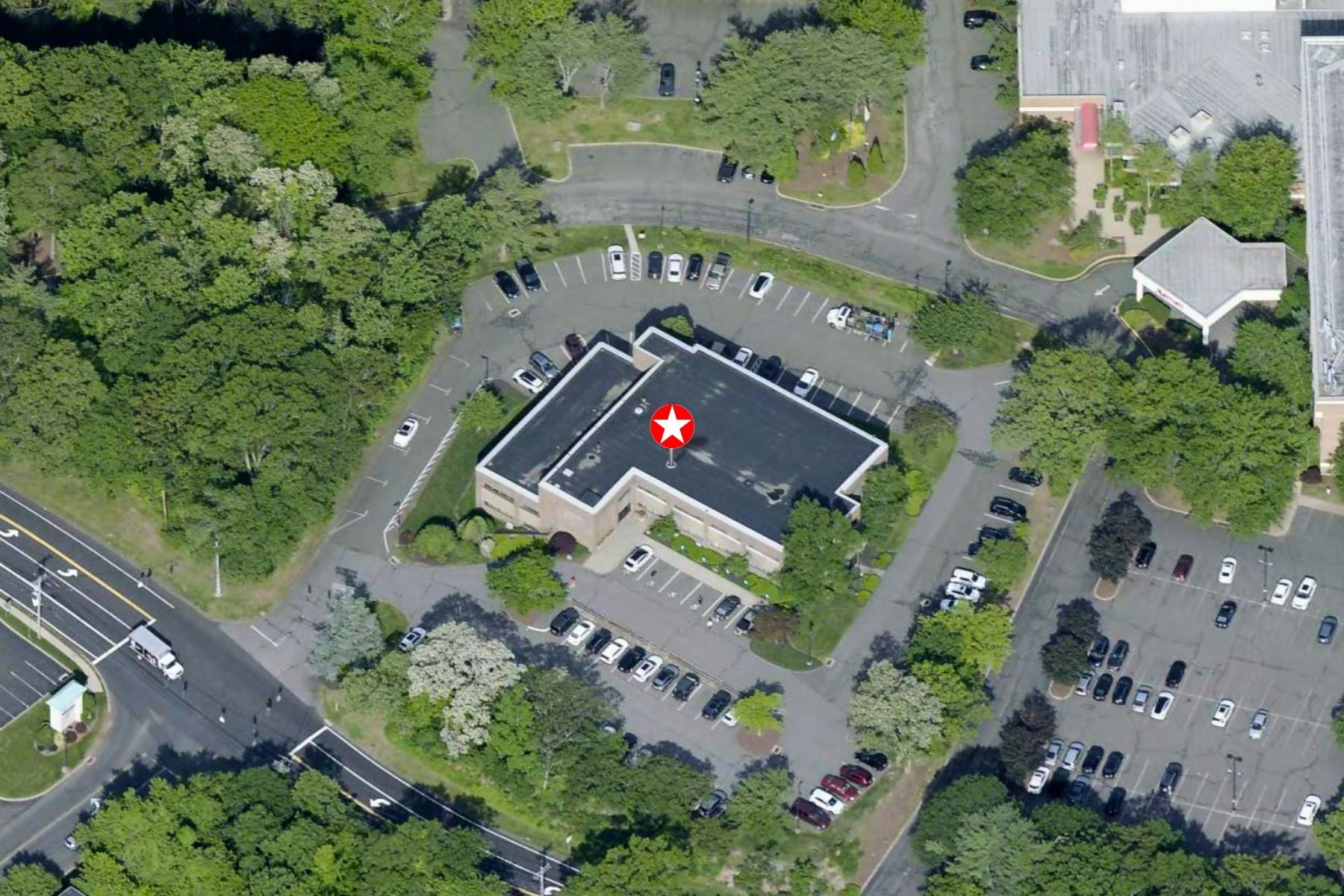 Abundant Parking with 140 Parking Spaces (6/1,000 SF) Aerial bird's-eye view of the Hawley Lane Professional Center building and its expansive 140-space shared parking lot in Trumbull, CT.