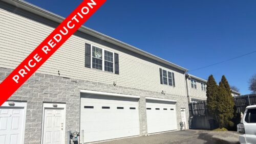 Exterior view of 15 South Street in Norwalk, CT, a 3,600 SF industrial flex building for sale featuring a drive-in door and a "Price Reduction" banner.