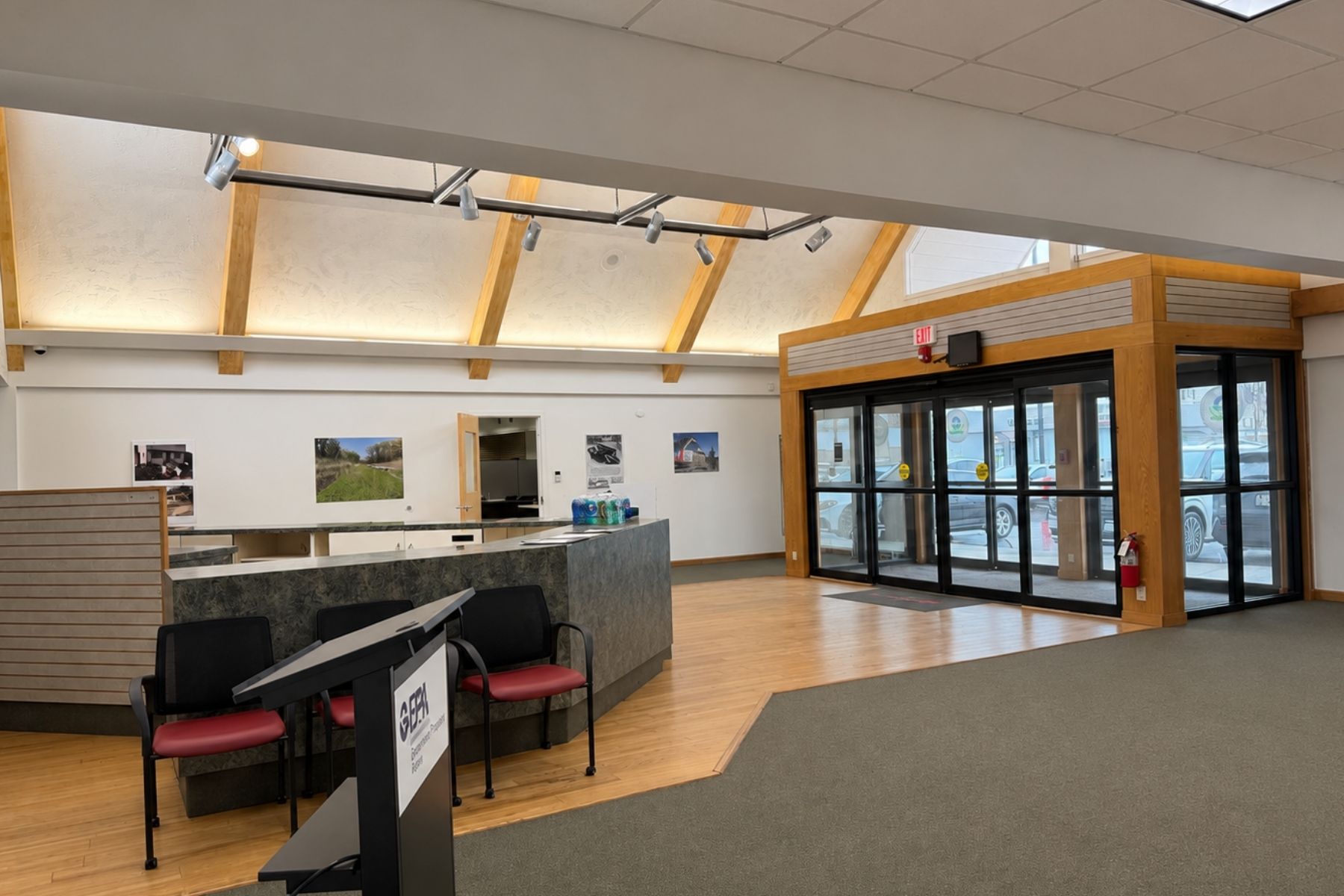 Prominent Glass-Front Retail Entrance Offering High Visibility and a Welcoming Transition for Customer Foot Traffic Commercial retail entrance featuring a large glass storefront, double glass doors, and view into an open showroom.