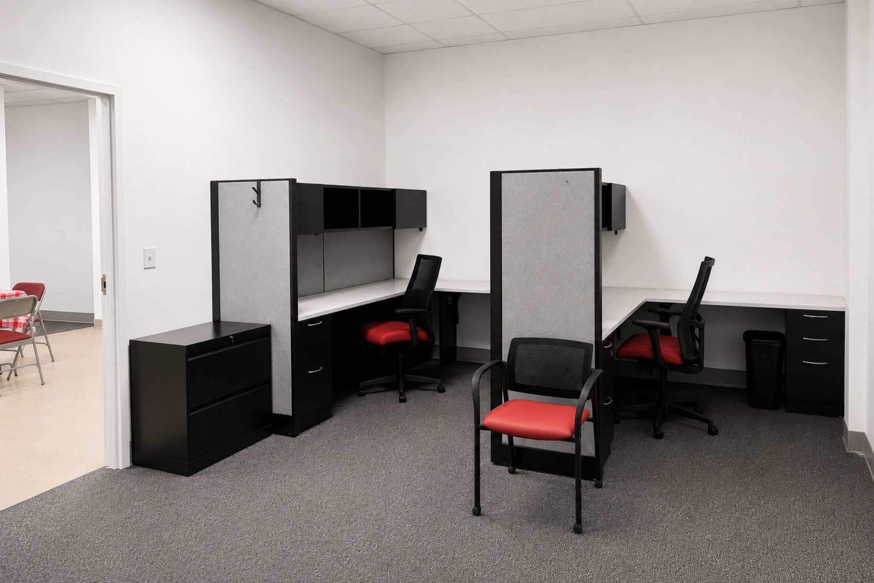 Private Administrative Office Wing Designed to Accommodate Multiple Individual Workstations and Specialized Storage Private administrative office wing featuring multiple individual cubicle workstations, black office chairs, and storage cabinets.