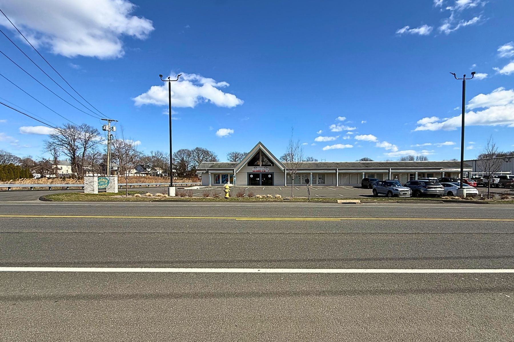 Prime Visibility & Access Front exterior view of the single-story commercial retail building from the street, showing the parking lot and wide frontage.