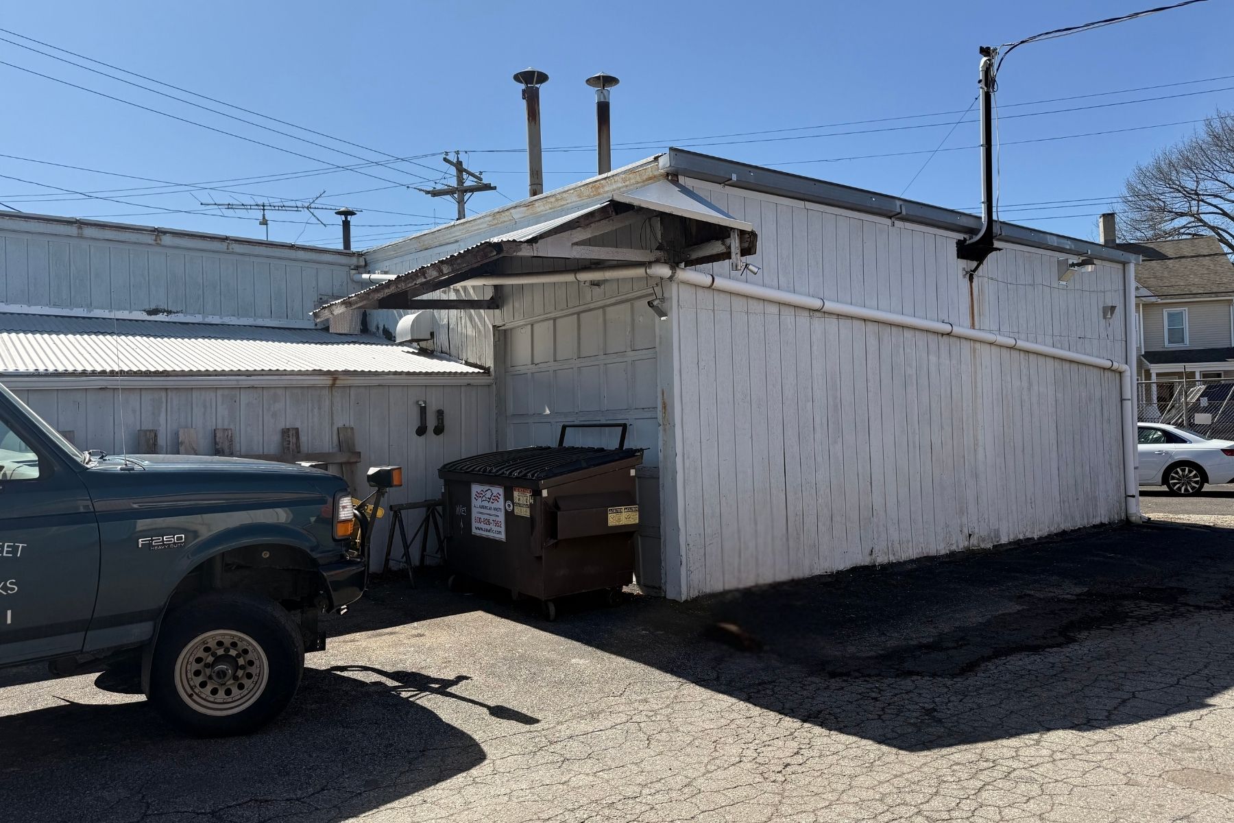 Secure Industrial Storage with Drive-In Door Exterior view of the 3,568 SF secondary warehouse building at 120 Silliman Avenue, Bridgeport, CT, featuring a metal facade and secure gated lot access.