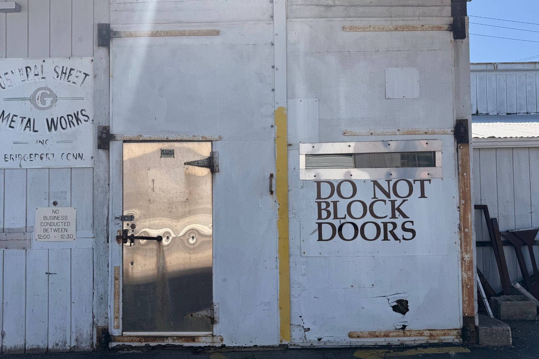 Heavy-Duty Double Swing Door with Entrance Door Exterior view of the heavy-duty double swing industrial doors with a secondary entrance door at 120 Silliman Avenue, Bridgeport, CT.