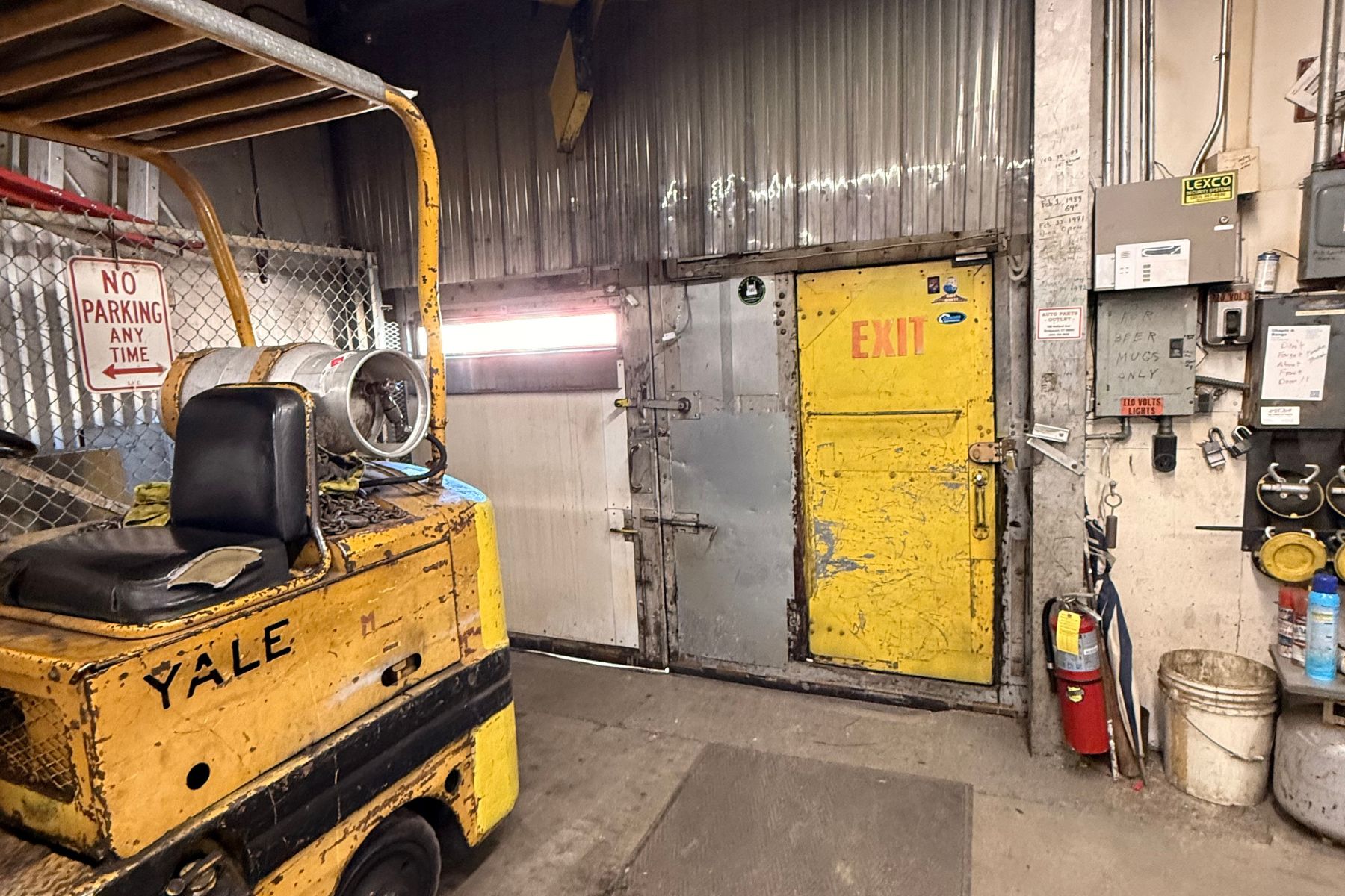 6 - Versatile Industrial Interior With 12' Clear Ceiling Heights Yellow forklift inside the industrial warehouse at 100-120 Silliman Avenue, Bridgeport, CT, demonstrating functional workspace for heavy equipment.