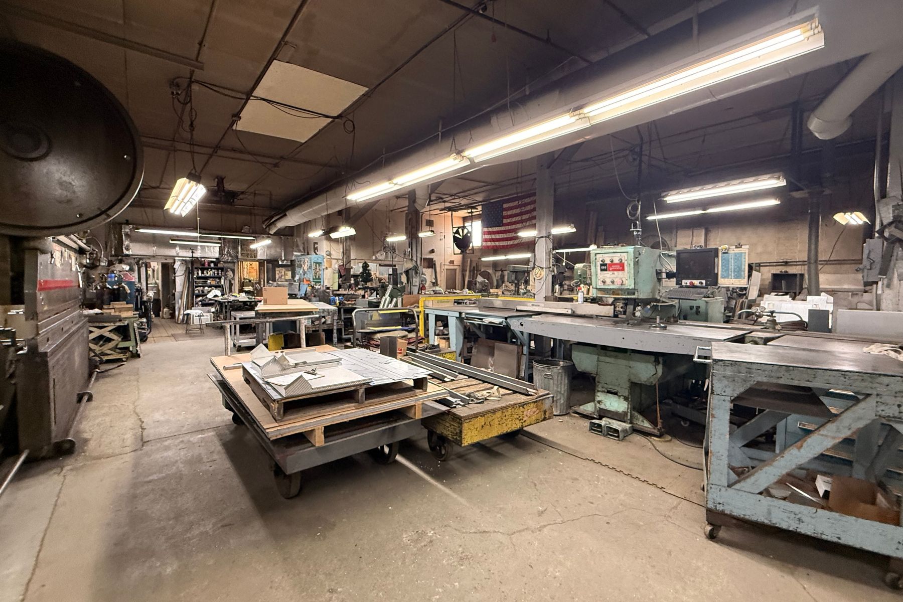 Versatile Industrial Interior With 12' Clear Ceiling Heights Spacious industrial warehouse interior at 120 Silliman Avenue, Bridgeport, CT, featuring high 12-foot ceilings, open floor plan for machinery, and fluorescent lighting.
