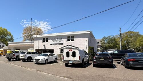 Front exterior view of the two-story industrial flex building at 20 Garland Drive, featuring stucco construction and a paved parking lot.