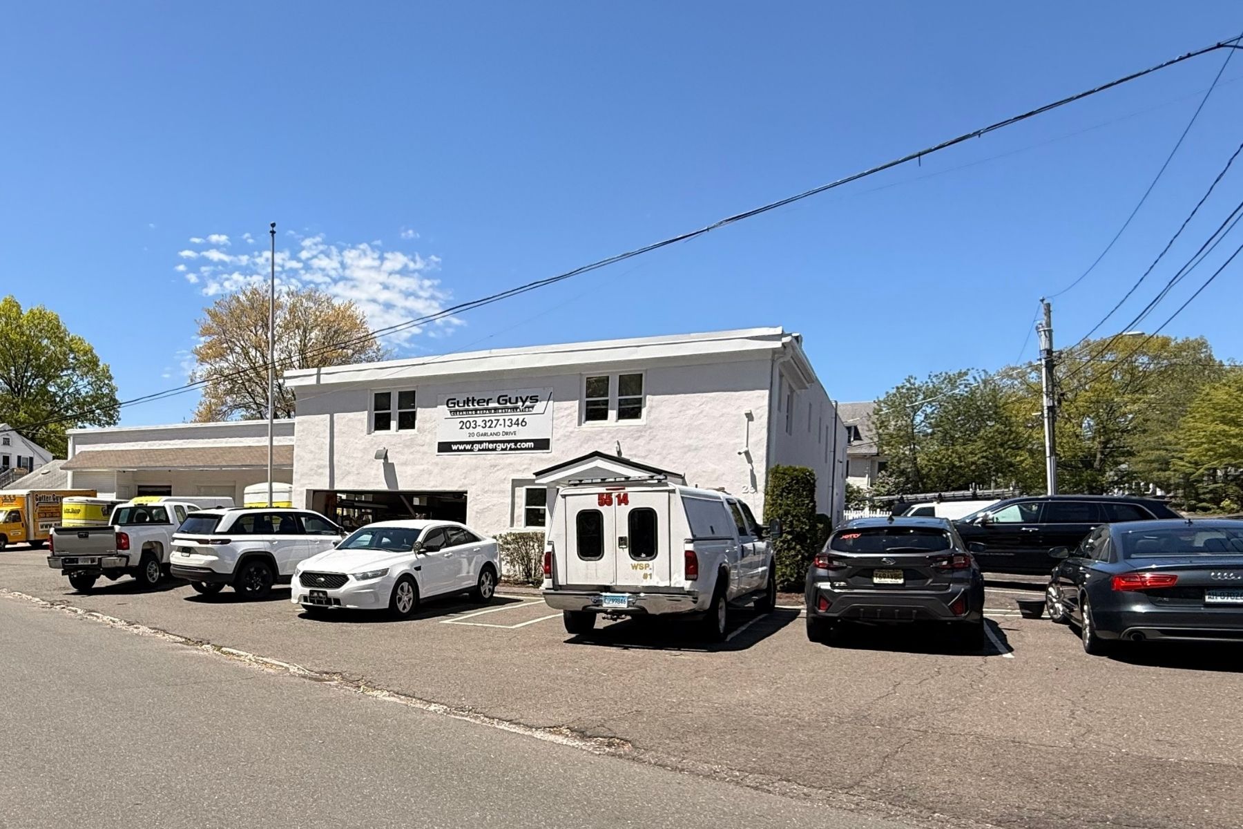 High-performance 12,736 SF industrial flex building at 20 Garland Drive, Stamford, CT, Front exterior view of the two-story industrial flex building at 20 Garland Drive, featuring stucco construction and a paved parking lot.