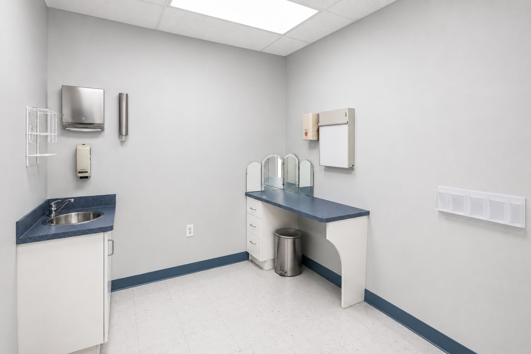 Plumbed for Medical Use with Seven Sinks Bright medical examination room featuring a built-in laminate countertop and an integrated stainless steel handwashing sink at Hawley Lane Professional Center in Trumbull, CT.