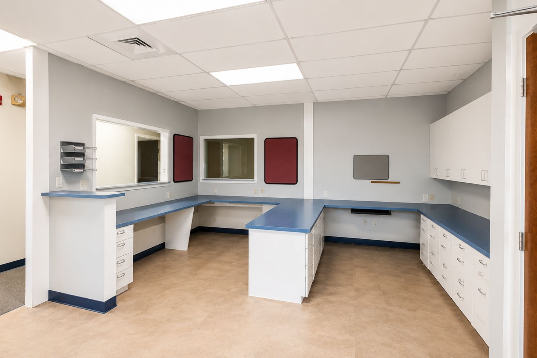 Large Administrative Office with Cabinetry Spacious medical administrative office and reception bullpen featuring custom wrap-around built-in desks, cabinetry, and countertops at Hawley Lane Professional Center in Trumbull, CT.