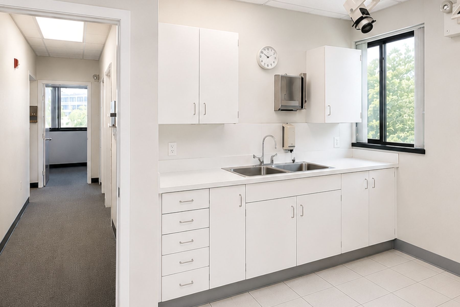 Diagnostic Lab or Break Room Bright medical diagnostic lab and staff break room featuring white laminate cabinetry, countertops, and a stainless steel handwashing sink at Hawley Lane Professional Center in Trumbull, CT.