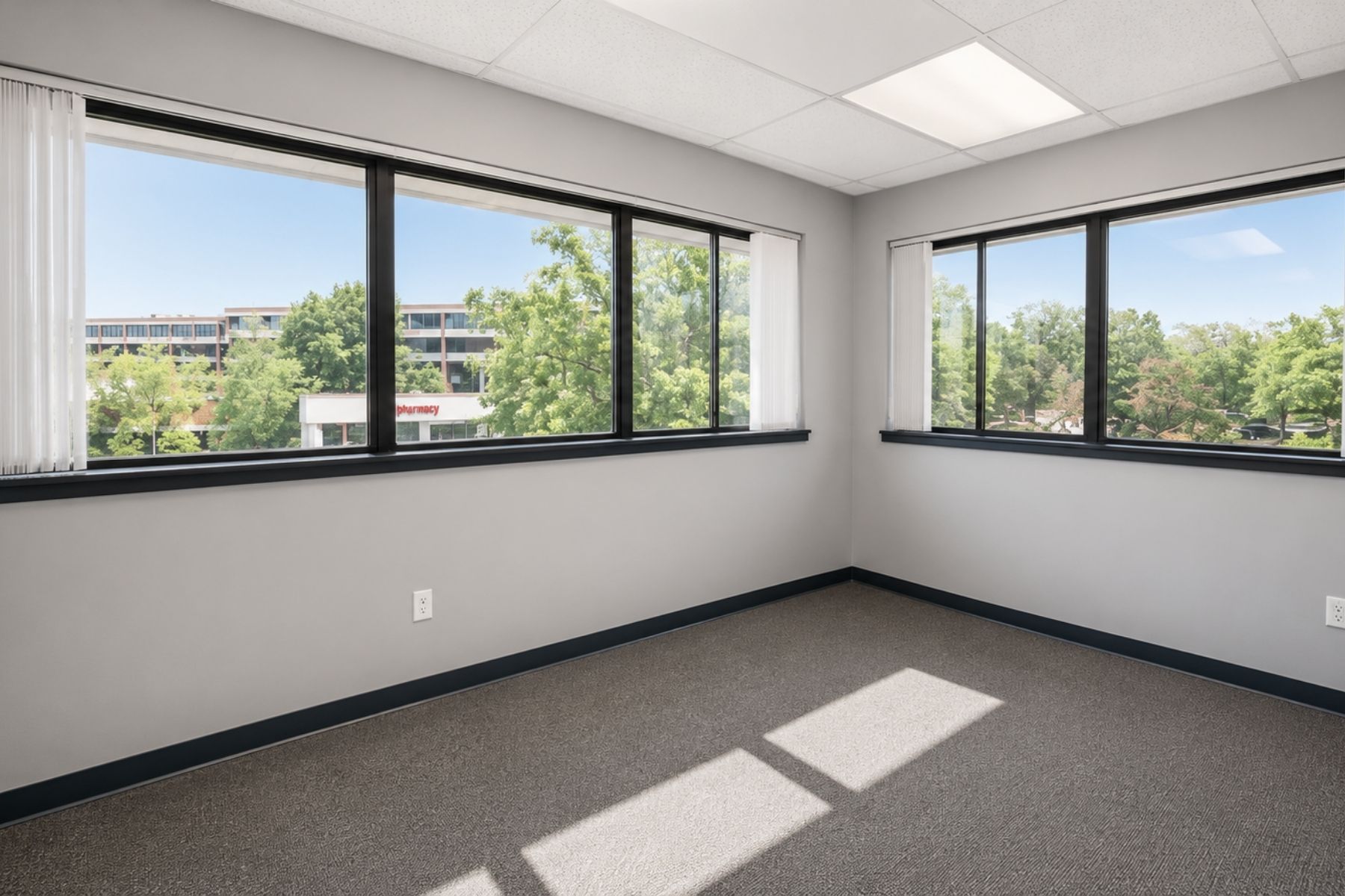 Bright Corner Suite with Offices Along Perimeter Bright, window-lined corner office suite featuring dark grey carpeting and perimeter windows at Hawley Lane Professional Center in Trumbull, CT.