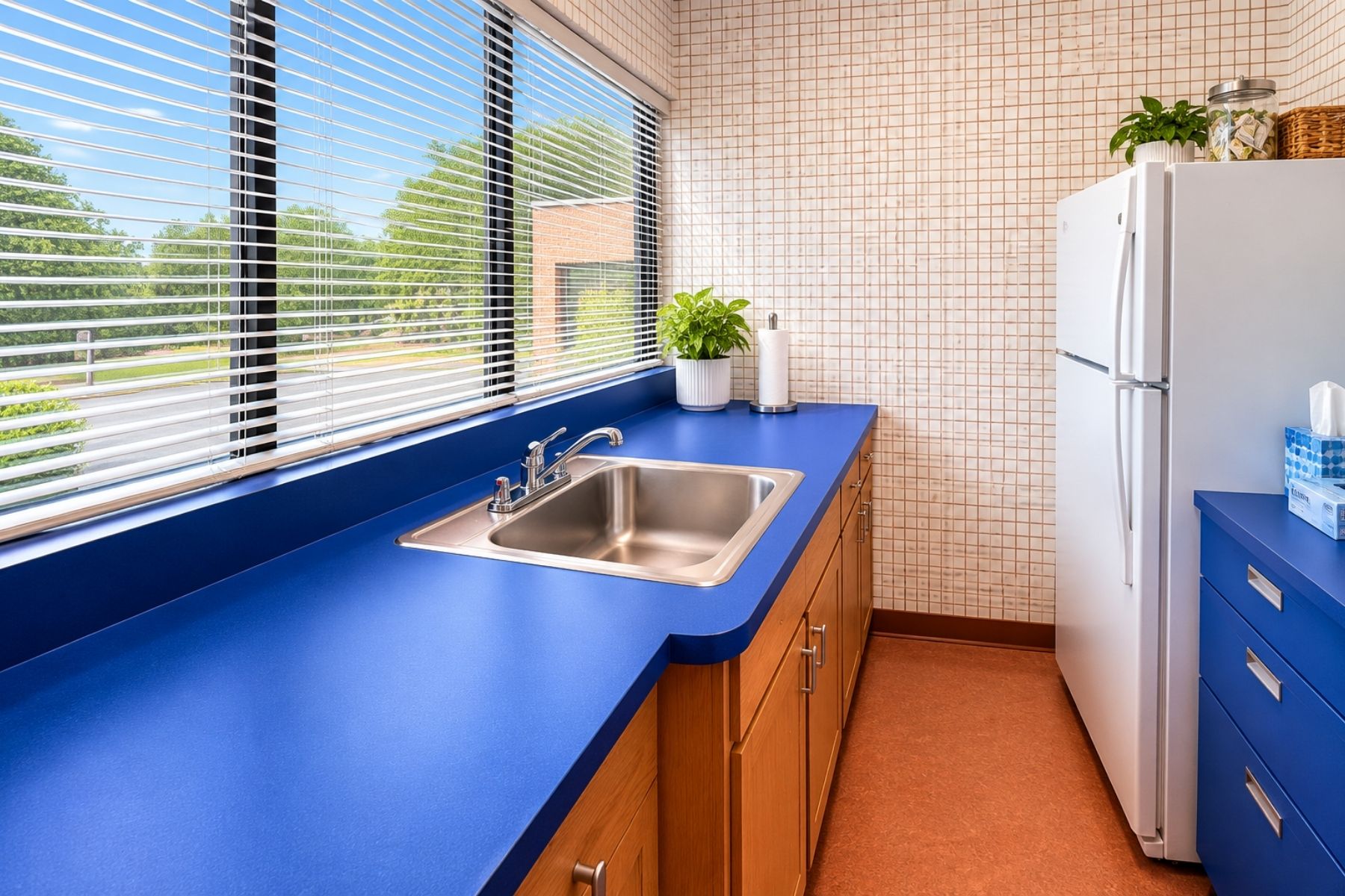 Windowed Kitchenette Bright Medical Office Kitchenette And Break Room Featuring Blue Countertops, Wood Cabinets, A Stainless Steel Sink, And A Large Window At Hawley Lane Professional Center In Trumbull, CT